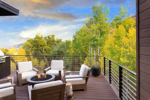 Deck featuring an outdoor living space with a fire pit and a grill