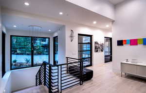 Stairs featuring wood finished floors and recessed lighting