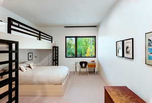 Bedroom with light carpet and baseboards