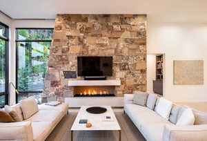 Living area featuring a stone fireplace
