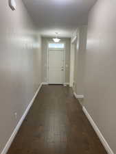 Hall featuring dark wood-style flooring and a textured ceiling