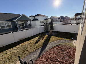 Fenced backyard featuring a residential view