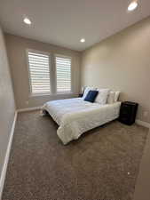 Carpeted bedroom with baseboards and recessed lighting