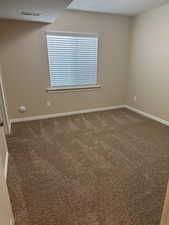 Carpeted empty room featuring a textured ceiling