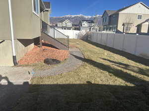 Fenced backyard with a residential view and a deck with mountain view