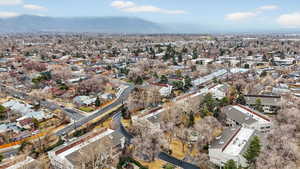 Aerial view of property's location with a mountain backdrop and nearby suburban area