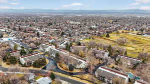 Aerial view of property's location with a golf club and nearby suburban area
