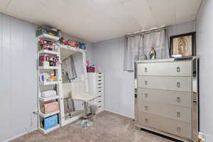 Bedroom featuring light carpet