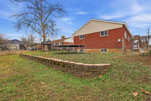 Rear view of property with brick siding and a gate