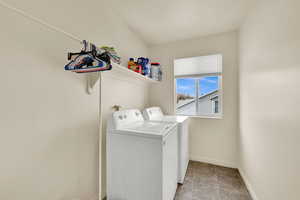 Laundry area with baseboards and washer and clothes dryer