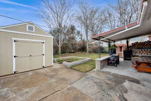 View of patio featuring a storage shed
