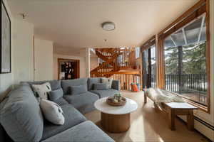 Living room featuring carpet flooring and stairway