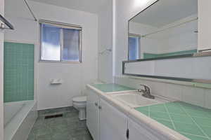 Bathroom with vanity and tub / shower combination