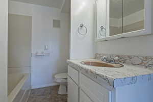 Full bath featuring vanity and a bath