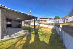 Fenced backyard with a patio