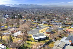 Aerial overview of property's location featuring nearby suburban area and a mountainous background