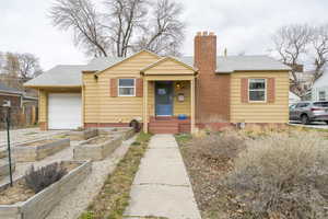 Bungalow-style house with raised garden beds