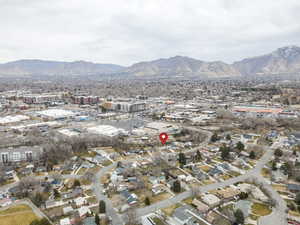 Aerial overview of property's location featuring a mountain backdrop and nearby urban area