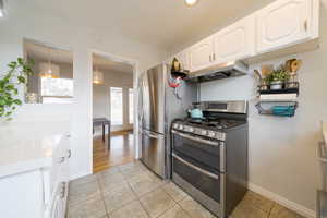 Kitchen off dining featuring gas range with two ovens