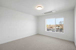 Empty room with carpet floors and cooling unit