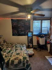 Bedroom with carpet and a ceiling fan