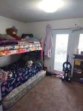 Carpeted bedroom with a textured ceiling