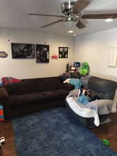 Living area with wood finished floors and ceiling fan