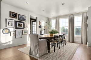 Dining space with light wood-type flooring and recessed lighting