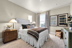 Bedroom with light colored carpet and a textured ceiling