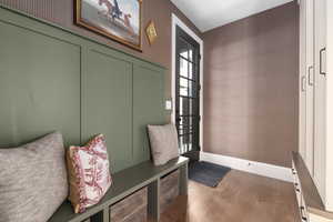 Mudroom featuring wood finished floors and baseboards