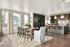 Dining room with dark wood-style flooring, recessed lighting, and a textured ceiling