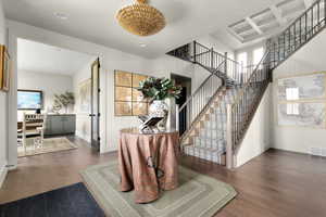Entryway with dark wood finished floors and coffered ceiling