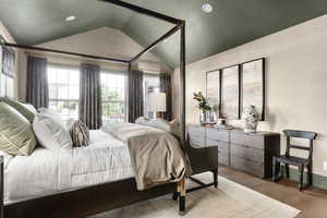Bedroom with wood finished floors, a textured ceiling, and recessed lighting