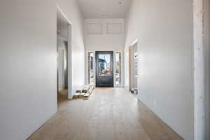 Corridor with a high ceiling and hardwood / wood-style floors