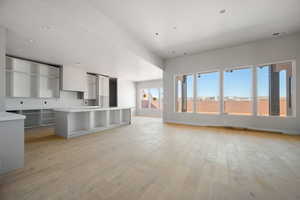 Kitchen with a center island, light wood-style floors, a breakfast bar area, and open floor plan