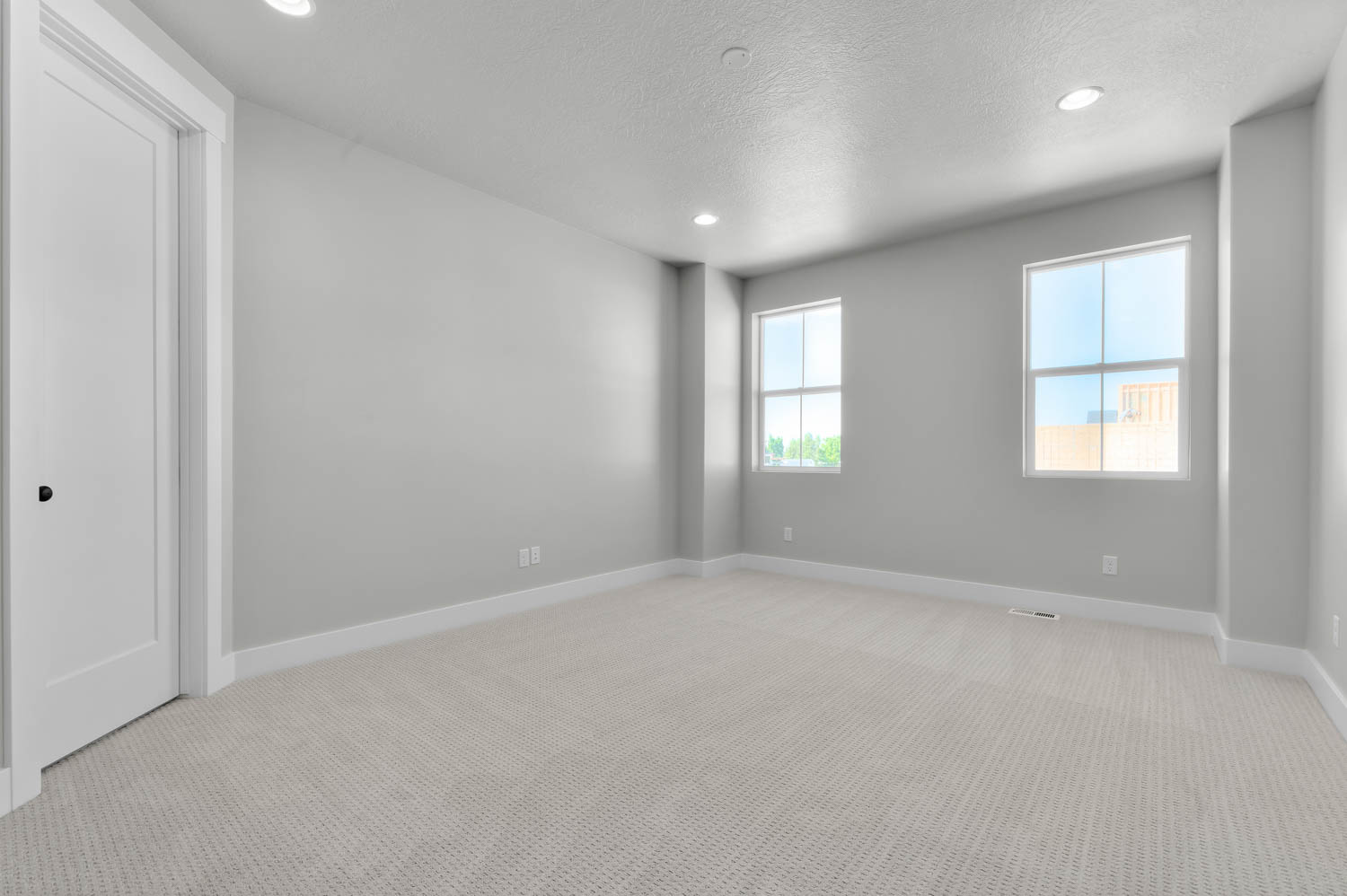 Spare room featuring light carpet, recessed lighting, and a textured ceiling