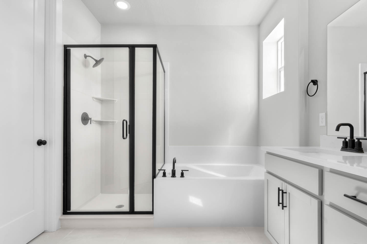 Full bath featuring vanity, a stall shower, a garden tub, light tile patterned floors, and recessed lighting