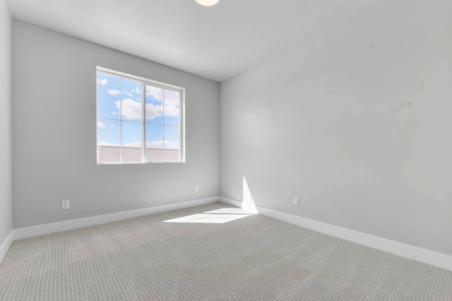 Carpeted empty room featuring baseboards