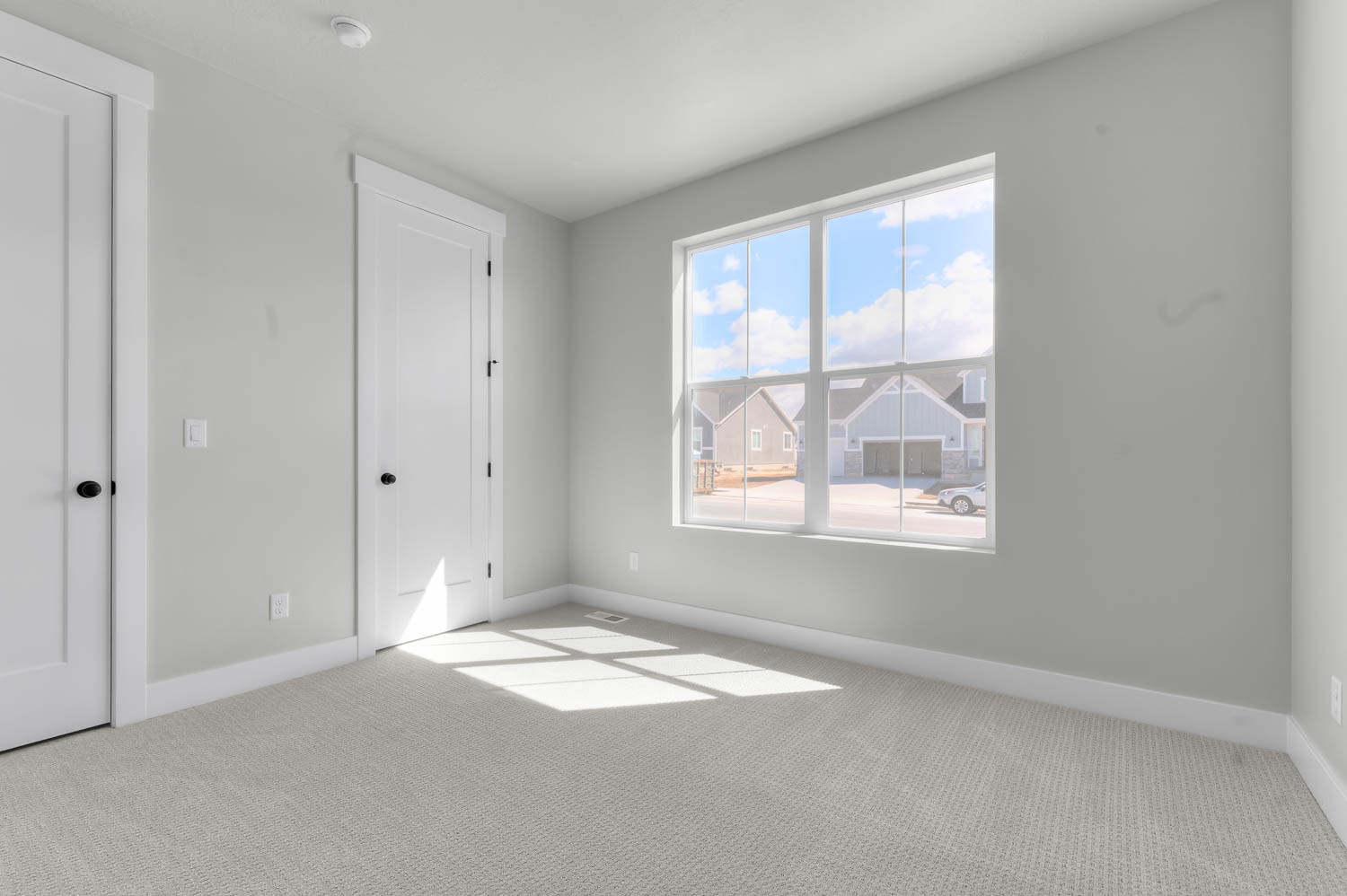 Unfurnished bedroom featuring light carpet and baseboards