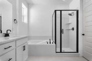 Full bath with vanity, a shower stall, and a bath