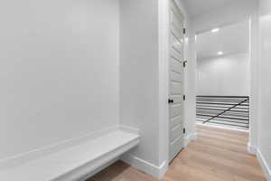 Mudroom with light wood-style floors and recessed lighting