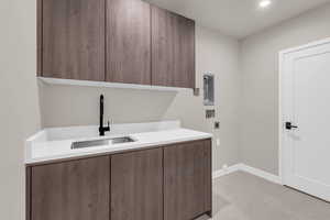 Laundry room with cabinet space, hookup for an electric dryer, washer hookup, and recessed lighting