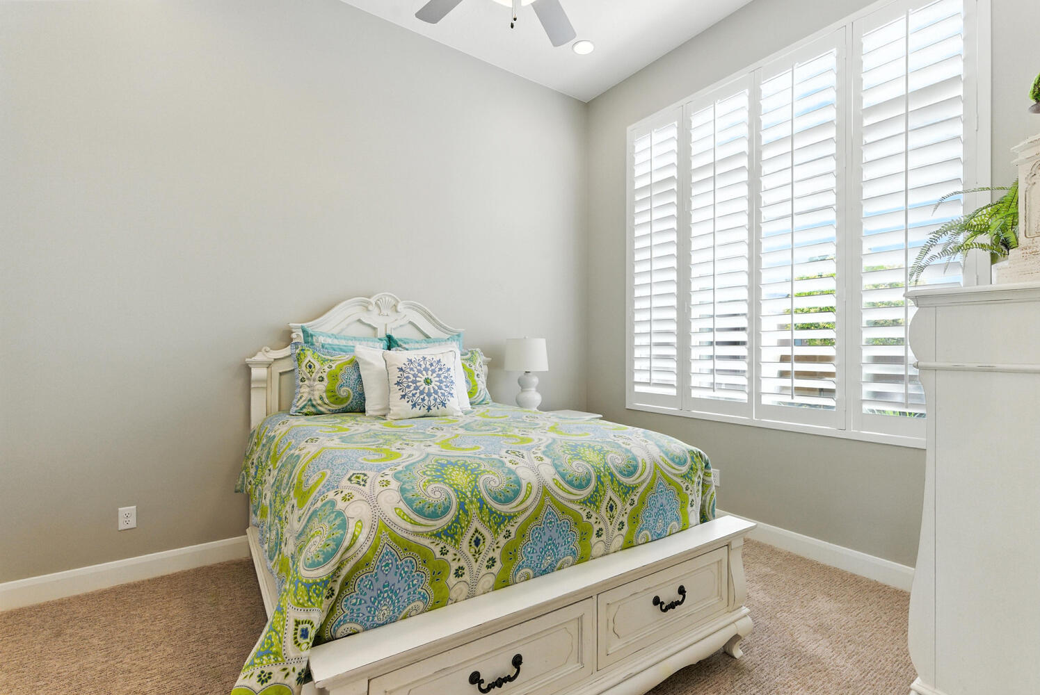 Bedroom featuring light colored carpet and a ceiling fan
