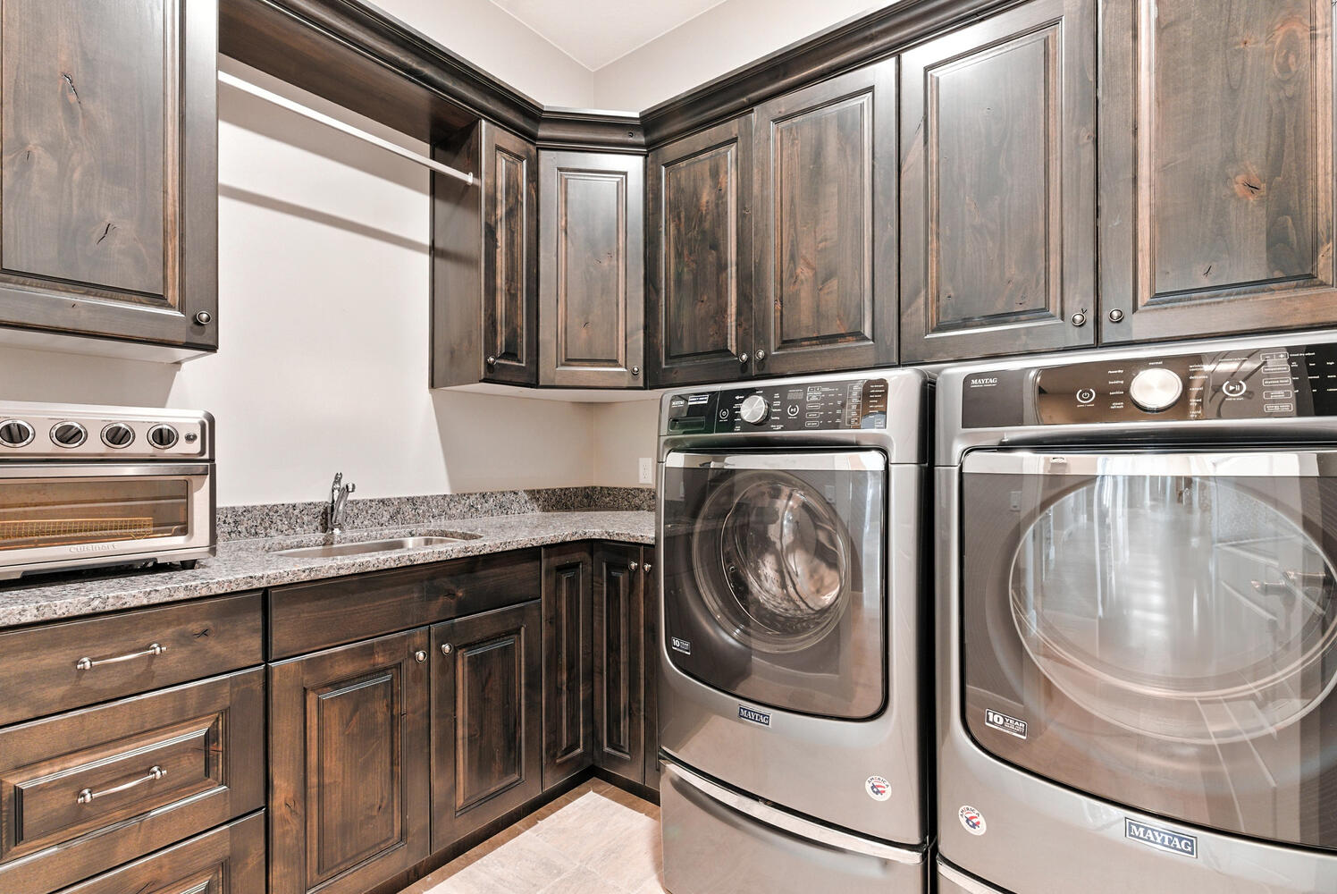 Laundry area featuring washer and clothes dryer and cabinet space