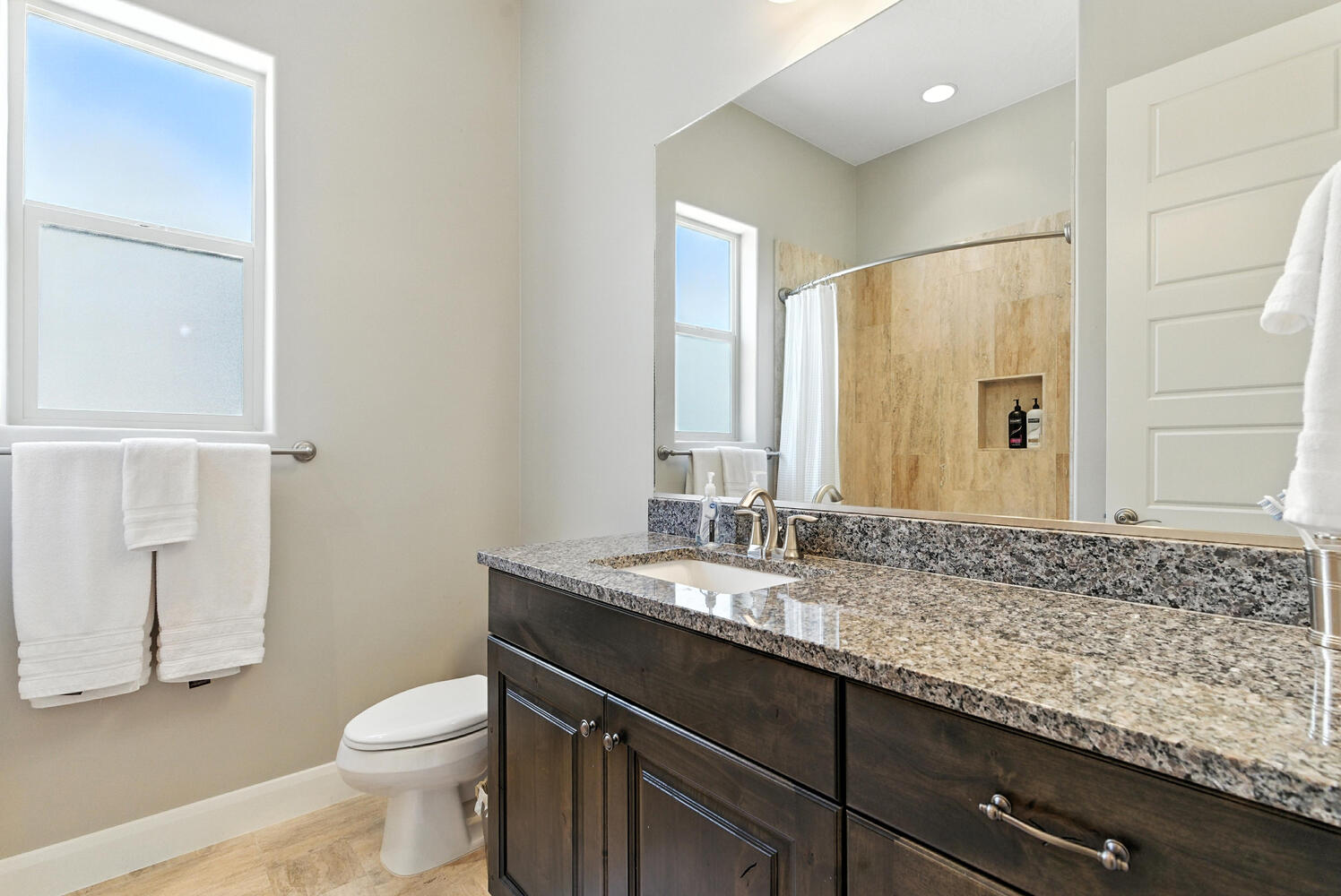 Full bath with vanity, a shower with curtain, and light wood-style floors