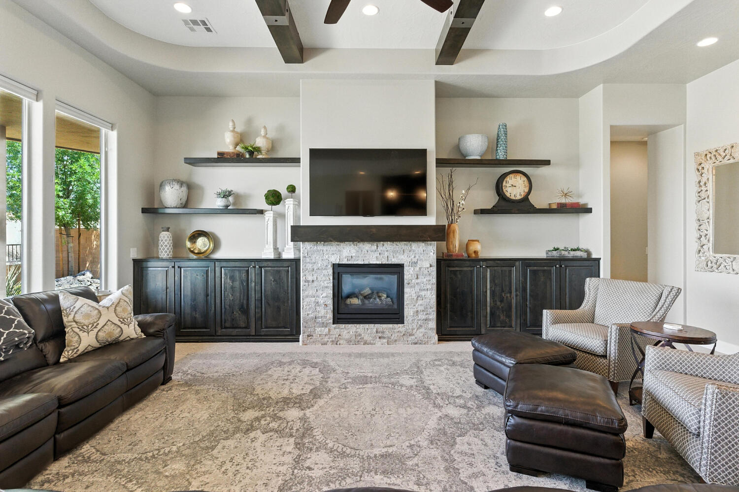 Living room featuring beamed ceiling, a fireplace, recessed lighting, and ceiling fan