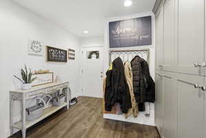 Foyer entrance with dark wood-style flooring and recessed lighting