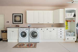 Laundry room with washer and dryer, cabinet space, and finished concrete floors