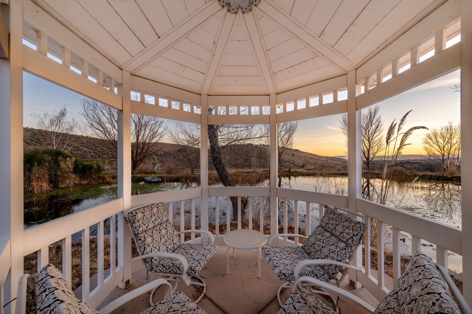 Sunroom / solarium with a water and mountain view