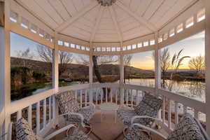 Sunroom / solarium with a water and mountain view